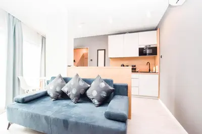 a kitchen with a table and a dining room at Apartamenty nad Wisłą in Kraków