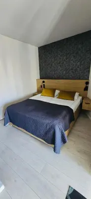 a kitchen and living room with a table and chairs at Apartamenty nad Wisłą in Kraków