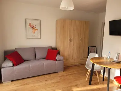 a living room with a couch and a table at Willa Wiesia Rabka Zdrój in Rabka