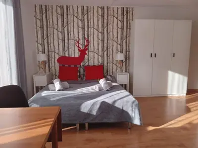 a bedroom with a bed with a red deer on it at Willa Wiesia Rabka Zdrój in Rabka