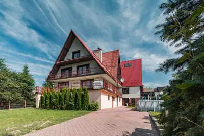 a house with a red roof and a brick driveway at Willa Wiesia Rabka Zdrój in Rabka