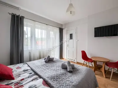 a bedroom with a bed and a table and chairs at Willa Wiesia Rabka Zdrój in Rabka