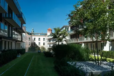 an apartment complex with a lawn in front of a building at Przy Wawelu z Garażem w cenie in Kraków