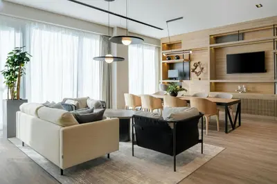 a living room with a couch and a table at AC Hotel by Marriott Krakow in Kraków