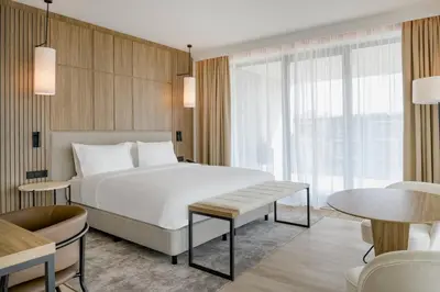 a hotel room with a bed and a table at AC Hotel by Marriott Krakow in Kraków