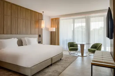 a hotel room with a bed and a table at AC Hotel by Marriott Krakow in Kraków