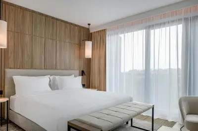 a bedroom with a white bed and a window at AC Hotel by Marriott Krakow in Kraków