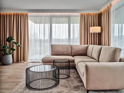 a living room with a couch and a table at AC Hotel by Marriott Krakow in Kraków