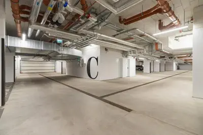 an empty room with a large c sign on the wall at Apartments Steam Park Old Town Cracow by Noclegi Renters in Kraków