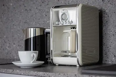 a coffee maker and a coffee cup on a counter at Apartments Steam Park Old Town Cracow by Noclegi Renters in Kraków