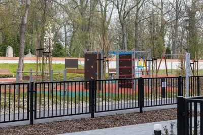 a park with a fence and a playground at Apartments Steam Park Old Town Cracow by Noclegi Renters in Kraków
