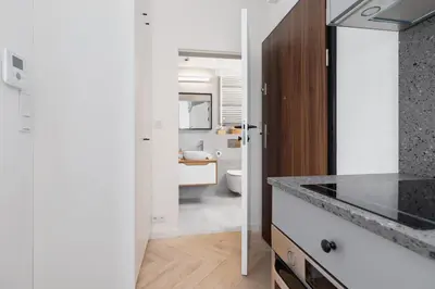 a white bathroom with a sink and a toilet at Apartments Steam Park Old Town Cracow by Noclegi Renters in Kraków