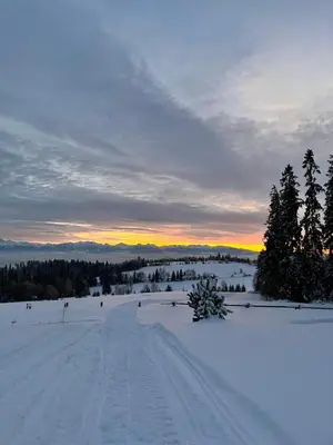 a group of people skiing on a snow covered field at U Kapiarza in Klikuszowa