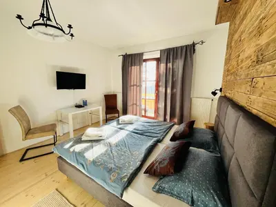 a bedroom with a desk and a bed and a table at U Kapiarza in Klikuszowa