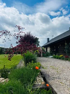 a garden in front of a house at Malinowa Chatka in Jankowice