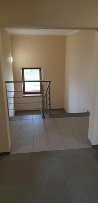 a empty room with a staircase and a window at Willa Czajki in Oświęcim