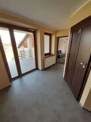 a room with a hallway with doors and a balcony at Willa Czajki in Oświęcim