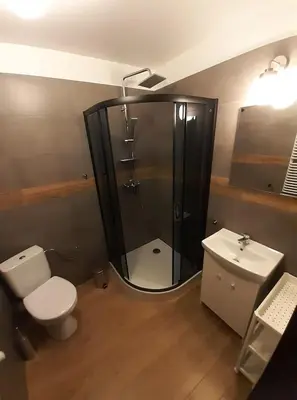 a bathroom with a shower and a toilet and a sink at Willa Czajki in Oświęcim