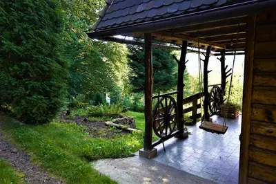 a pavilion in a garden next to a house at Rudera u Sióstr DREWNIANY DOMEK Stróża in Stróża