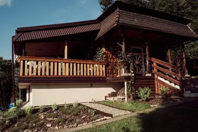 a house with a large deck on the side of it at Rudera u Sióstr DREWNIANY DOMEK Stróża in Stróża