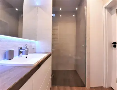 a bathroom with a sink and a shower at MOGILSKA Apartments near Tauron Arena Krakow in Kraków