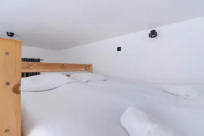 a white bedroom with two white pillows on a bed at Apartment Joselewicza Cracow Kazimierz by Noclegi Renters in Kraków