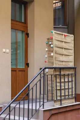 a building with a staircase and a wooden door at Apartment Joselewicza Cracow Kazimierz by Noclegi Renters in Kraków