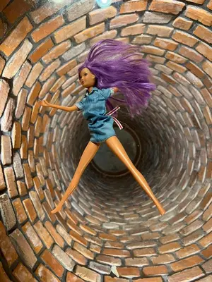 a doll with purple hair is on a brick tunnel at 22 Kąty in Radziemice
