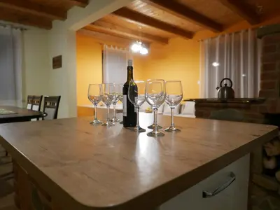 a bottle of wine and wine glasses on a counter at 22 Kąty in Radziemice