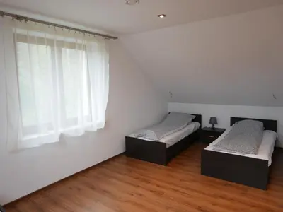 two beds in a room with a window at 22 Kąty in Radziemice