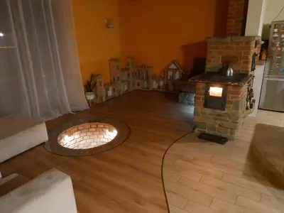 a living room with a brick fireplace and a fire pit at 22 Kąty in Radziemice