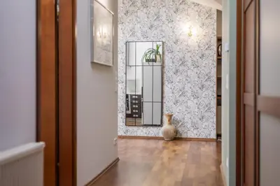 a living room with a wooden door and a table at Extravaganza in Kraków