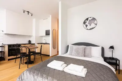 a bedroom with a bed with two towels on it at Apartments nearto Main Railway Station in Kraków