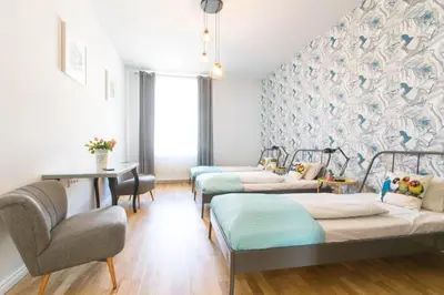 a room with three beds and a table and chairs at Krupnicza Modern Old Town Apartments - by Upstairs in Kraków
