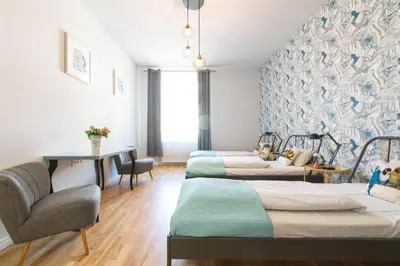 a room with three beds and a table and chairs at Krupnicza Modern Old Town Apartments - by Upstairs in Kraków