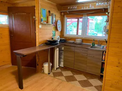 a kitchen with a wooden counter and a sink at Ranczo Wilka z kominkiem in Chrzanów