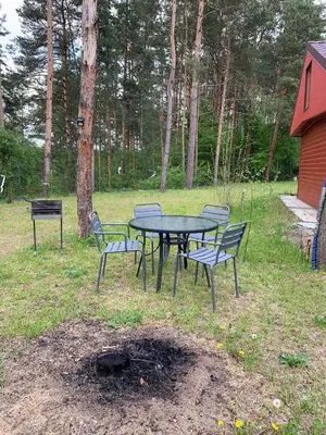 a picnic table and chairs in a yard at Ranczo Wilka z kominkiem in Chrzanów