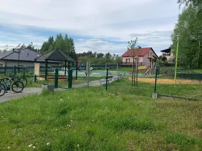 a park with a playground with a bike in the grass at Ranczo Wilka z kominkiem in Chrzanów
