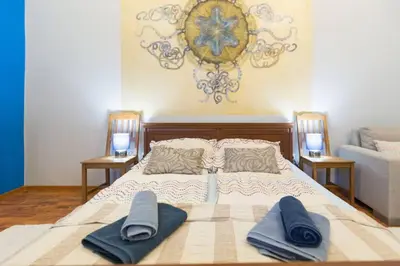 a bedroom with a bed with two blue towels on it at The quiet blue home in the city center! in Kraków