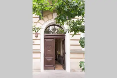 an entrance to a building with a brown door at The quiet blue home in the city center! in Kraków