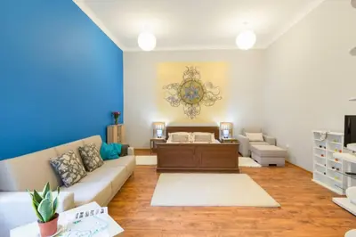 a living room with a couch and a table at The quiet blue home in the city center! in Kraków