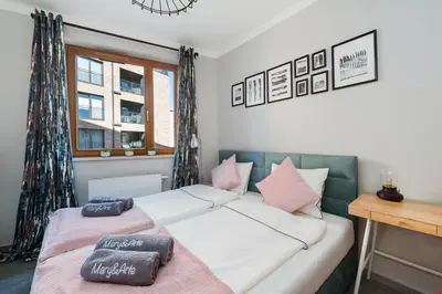 a bedroom with a bed with pillows on it at Mary&Arte Apartments Browar Lubicz in Kraków