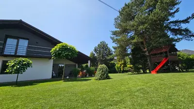 a house with a yard with green grass at Apartament Willa Pod Sosnami Zator Przeciszów in Zator