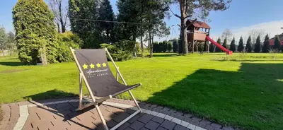 a sign in a park with a playground at Apartament Willa Pod Sosnami Zator Przeciszów in Zator