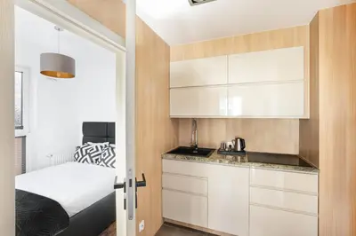 a living room with a large flat screen tv on a wall at Apartamenty Platinex 3 in Kraków