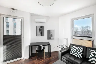 a living room with a couch and a table at Apartamenty Platinex 3 in Kraków