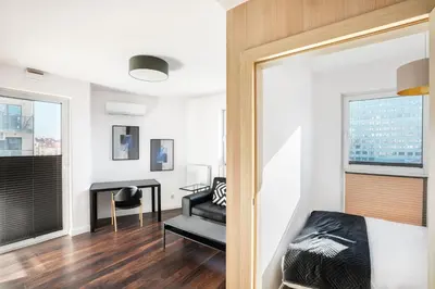 a bedroom with a bed and a desk at Apartamenty Platinex 3 in Kraków