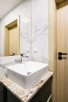 a bathroom with a washing machine and a toilet at Apartamenty Platinex 3 in Kraków