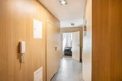 a white bathroom with a sink and a mirror at Apartamenty Platinex 3 in Kraków