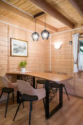 a porch of a wooden cabin with a door at Andrzejówka in Kocoń